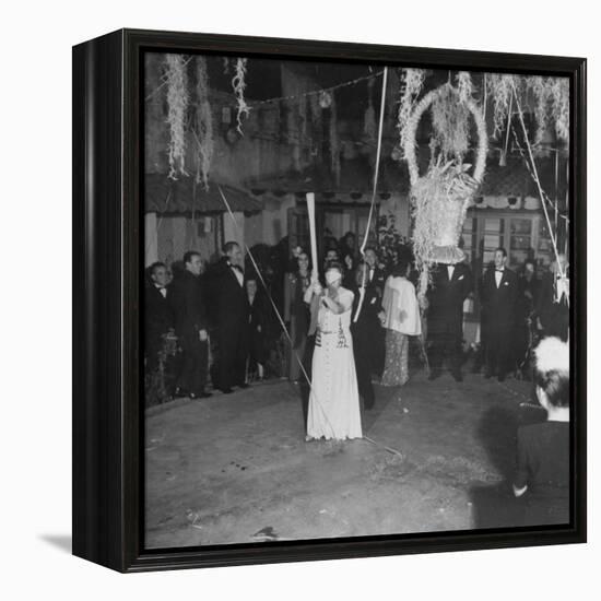 Blind Folded Woman Trying to Split Open the Pinata, During Traditional Pre-Christmas Celebration-Ed Clark-Framed Premier Image Canvas