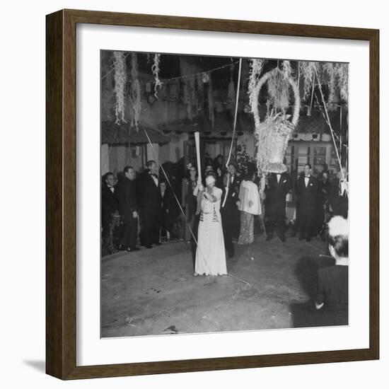 Blind Folded Woman Trying to Split Open the Pinata, During Traditional Pre-Christmas Celebration-Ed Clark-Framed Photographic Print