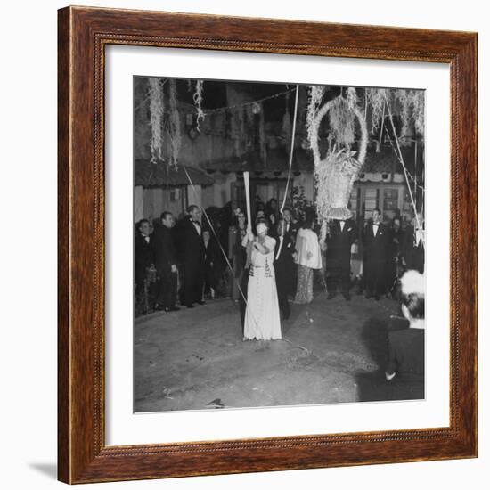 Blind Folded Woman Trying to Split Open the Pinata, During Traditional Pre-Christmas Celebration-Ed Clark-Framed Photographic Print