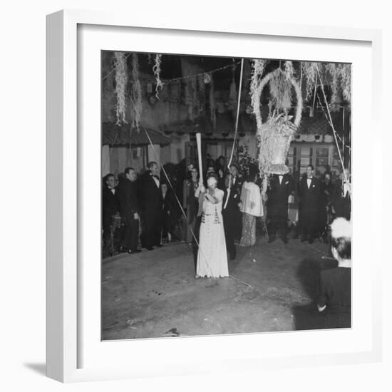 Blind Folded Woman Trying to Split Open the Pinata, During Traditional Pre-Christmas Celebration-Ed Clark-Framed Photographic Print