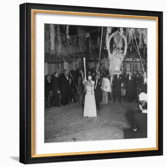 Blind Folded Woman Trying to Split Open the Pinata, During Traditional Pre-Christmas Celebration-Ed Clark-Framed Photographic Print