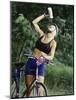 Blond Bicyclist Cooling Off with Bottled Water-null-Mounted Photographic Print