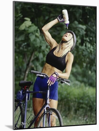 Blond Bicyclist Cooling Off with Bottled Water-null-Mounted Photographic Print