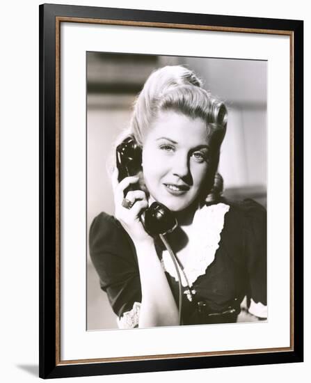 Blonde Woman Holding Telephone Receiver-null-Framed Photo