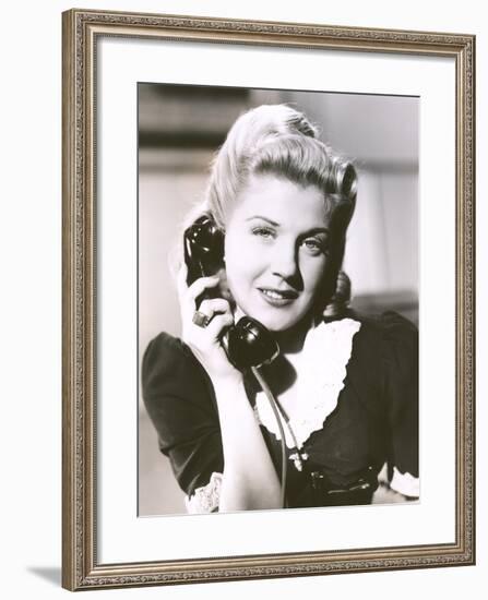 Blonde Woman Holding Telephone Receiver-null-Framed Photo