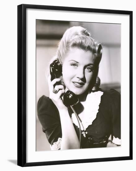 Blonde Woman Holding Telephone Receiver-null-Framed Photo