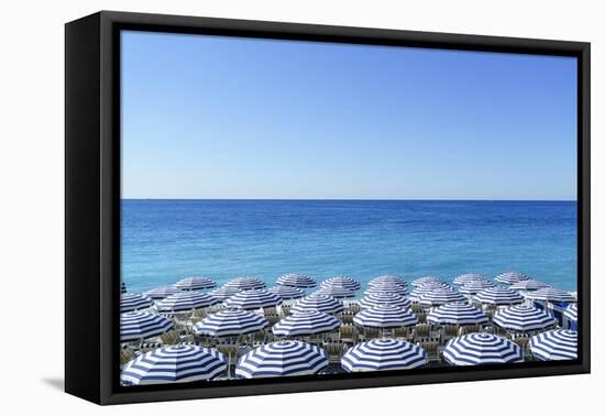 Blue and white beach parasols, Nice, Cote d'Azur, Alpes-Maritimes, Provence, French Riviera, France-Fraser Hall-Framed Premier Image Canvas