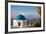 Blue domed Greek Orthodox church with bougainvillea flowers in Oia, Santorini, Greece.-Michele Niles-Framed Photographic Print