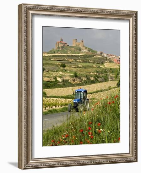 Blue tractor on rural road, San Vicente de la Sonsierra Village, La Rioja, Spain-Janis Miglavs-Framed Photographic Print