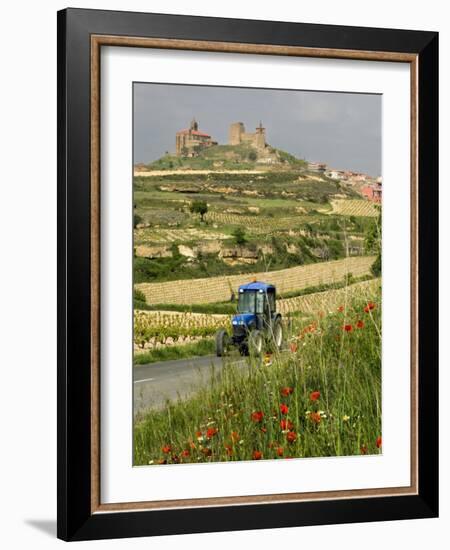 Blue tractor on rural road, San Vicente de la Sonsierra Village, La Rioja, Spain-Janis Miglavs-Framed Photographic Print