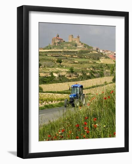 Blue tractor on rural road, San Vicente de la Sonsierra Village, La Rioja, Spain-Janis Miglavs-Framed Photographic Print