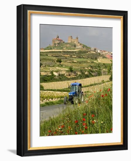 Blue tractor on rural road, San Vicente de la Sonsierra Village, La Rioja, Spain-Janis Miglavs-Framed Photographic Print