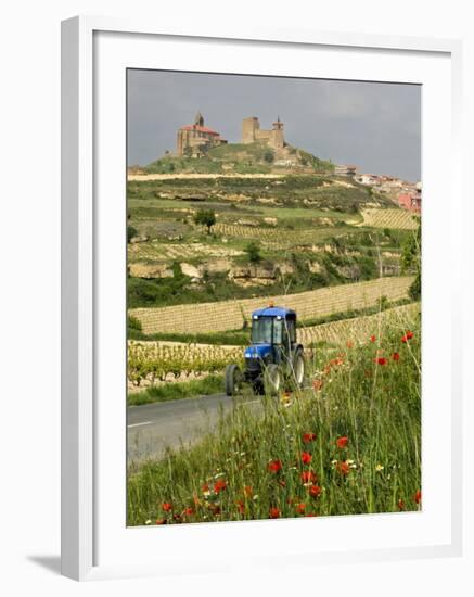 Blue tractor on rural road, San Vicente de la Sonsierra Village, La Rioja, Spain-Janis Miglavs-Framed Photographic Print