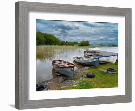 Boats await skippers on Lough Carra, County Mayo, Ireland. Shrine watches over the fishermen.-Betty Sederquist-Framed Photographic Print