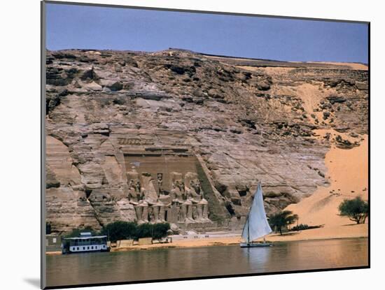 Boats on Nile River Passing Massive Statues of Pharoh Ramses II at Door to Queen Nefertari's Temple-James Burke-Mounted Photographic Print