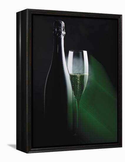 Bottle and Glass of Sparkling Wine in Green Light-null-Framed Premier Image Canvas