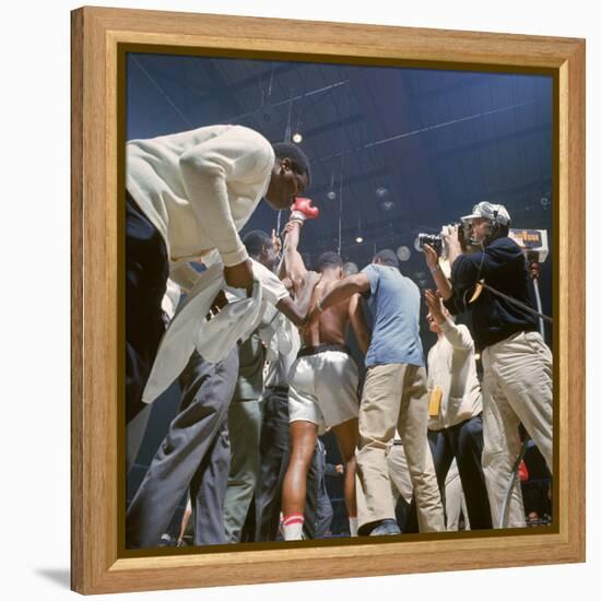 Boxer Cassius Clay, aka Muhammad Ali, Raising Fist in Triumph After Beating Sonny Liston-John Dominis-Framed Premier Image Canvas