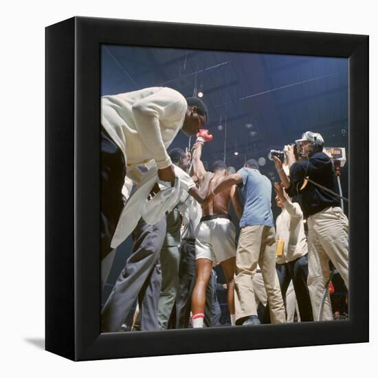 Boxer Cassius Clay, aka Muhammad Ali, Raising Fist in Triumph After Beating Sonny Liston-John Dominis-Framed Premier Image Canvas