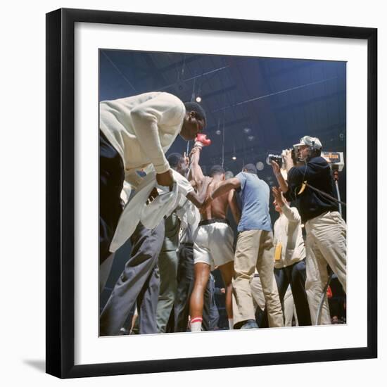 Boxer Cassius Clay, aka Muhammad Ali, Raising Fist in Triumph After Beating Sonny Liston-John Dominis-Framed Premium Photographic Print