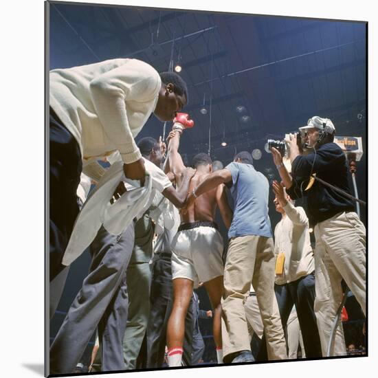 Boxer Cassius Clay, aka Muhammad Ali, Raising Fist in Triumph After Beating Sonny Liston-John Dominis-Mounted Premium Photographic Print