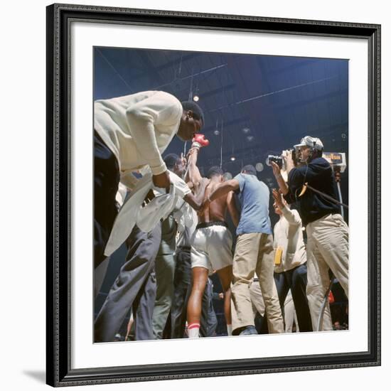 Boxer Cassius Clay, aka Muhammad Ali, Raising Fist in Triumph After Beating Sonny Liston-John Dominis-Framed Premium Photographic Print