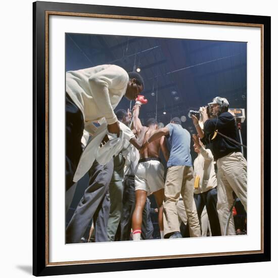 Boxer Cassius Clay, aka Muhammad Ali, Raising Fist in Triumph After Beating Sonny Liston-John Dominis-Framed Premium Photographic Print