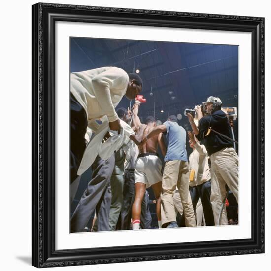 Boxer Cassius Clay, aka Muhammad Ali, Raising Fist in Triumph After Beating Sonny Liston-John Dominis-Framed Premium Photographic Print