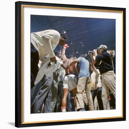 Boxer Cassius Clay, aka Muhammad Ali, Raising Fist in Triumph After Beating Sonny Liston-John Dominis-Framed Premium Photographic Print