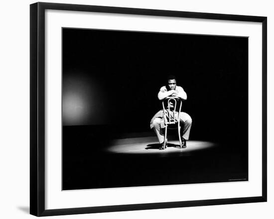 Boxer Joe Frazier Sitting on a Chair under a Spotlight-John Shearer-Framed Premium Photographic Print