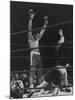 Boxer Muhammad Ali Raising His Gloves Victoriously After Knocking Out Oscar Bonavena-Bill Ray-Mounted Premium Photographic Print