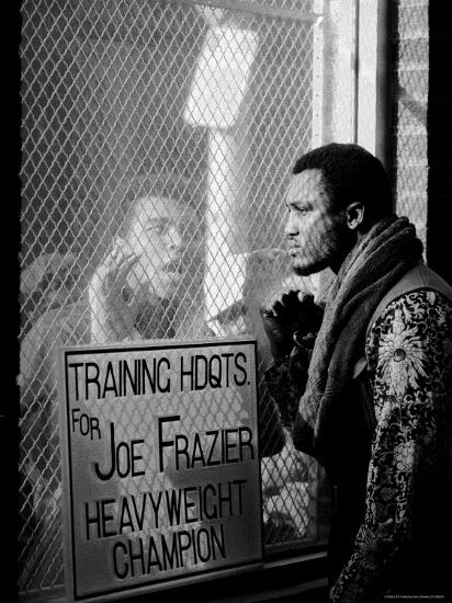 Boxer Muhammad Ali Taunting Rival Joe Frazier at Frazier's Training Headquarters-John Shearer-Framed Premium Photographic Print