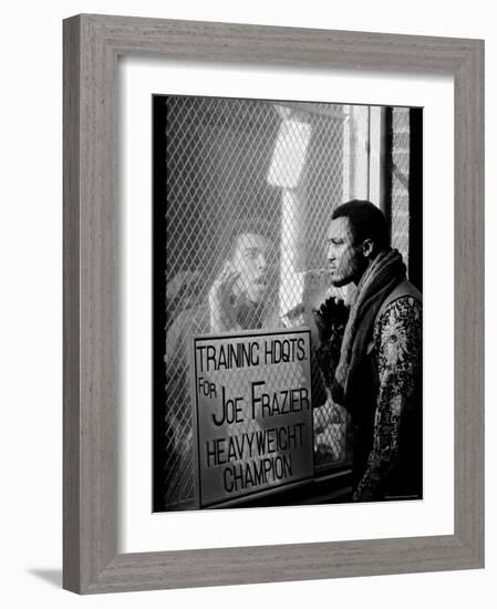 Boxer Muhammad Ali Taunting Rival Joe Frazier at Frazier's Training Headquarters-John Shearer-Framed Premium Photographic Print