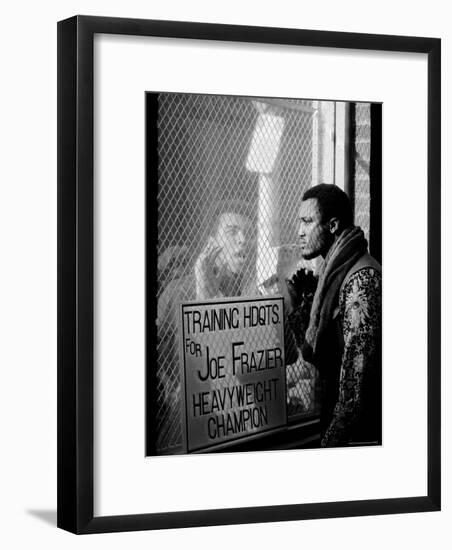 Boxer Muhammad Ali Taunting Rival Joe Frazier at Frazier's Training Headquarters-John Shearer-Framed Premium Photographic Print