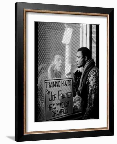 Boxer Muhammad Ali Taunting Rival Joe Frazier at Frazier's Training Headquarters-John Shearer-Framed Premium Photographic Print