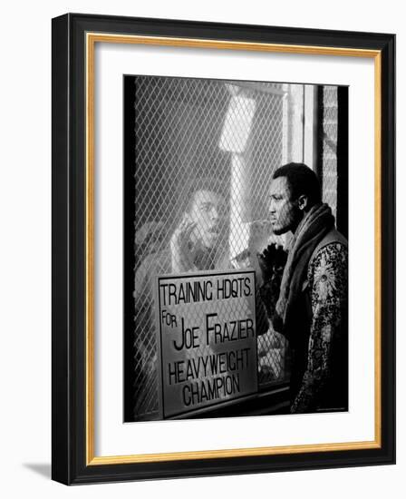 Boxer Muhammad Ali Taunting Rival Joe Frazier at Frazier's Training Headquarters-John Shearer-Framed Premium Photographic Print