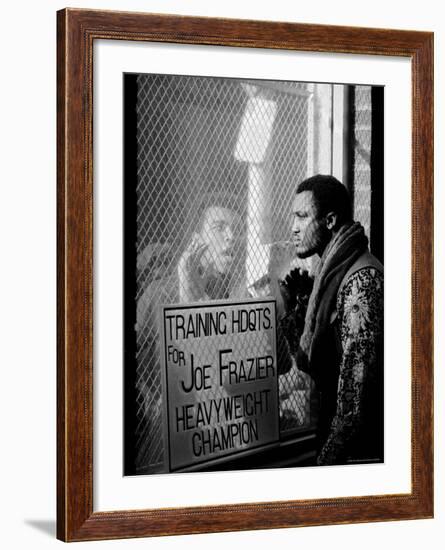 Boxer Muhammad Ali Taunting Rival Joe Frazier at Frazier's Training Headquarters-John Shearer-Framed Premium Photographic Print