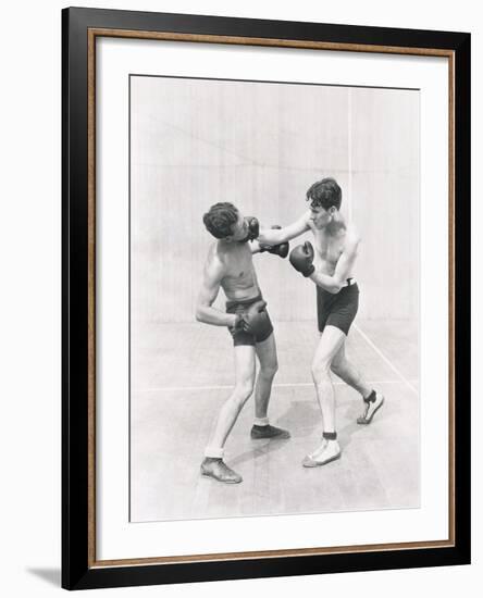 Boxer Throwing a Right Hook-null-Framed Photo