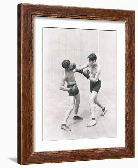 Boxer Throwing a Right Hook-null-Framed Photo