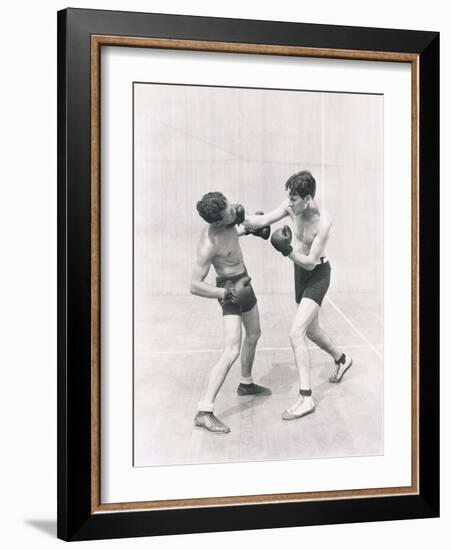 Boxer Throwing a Right Hook-null-Framed Photo