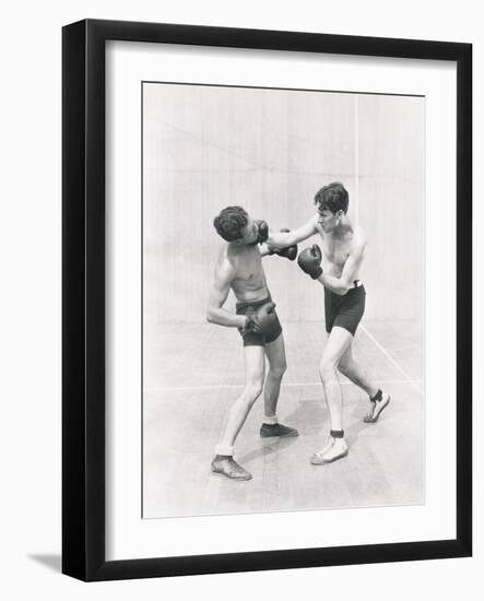 Boxer Throwing a Right Hook-null-Framed Photo