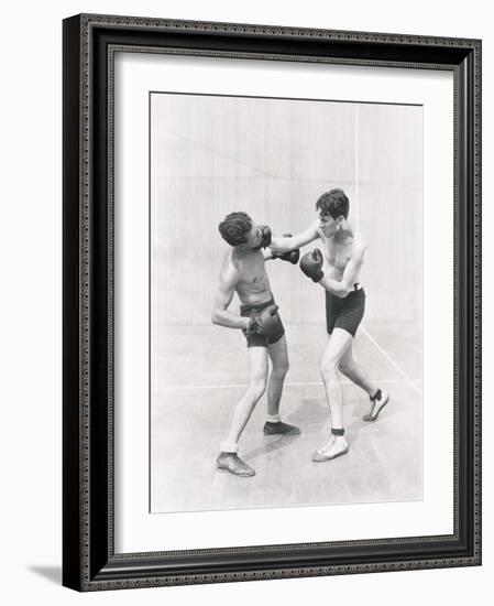 Boxer Throwing a Right Hook-null-Framed Photo