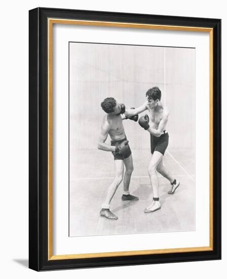 Boxer Throwing a Right Hook-null-Framed Photo