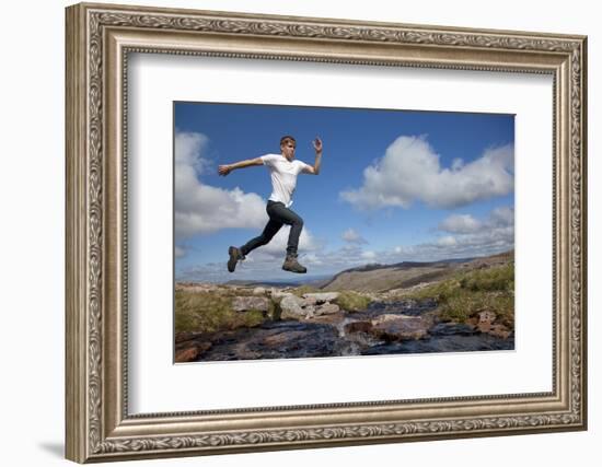 Boy (Aged 17) Jumping across Upland Stream-Mark Hamblin-Framed Photographic Print