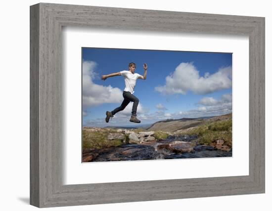 Boy (Aged 17) Jumping across Upland Stream-Mark Hamblin-Framed Photographic Print