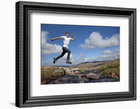 Boy (Aged 17) Jumping across Upland Stream-Mark Hamblin-Framed Photographic Print