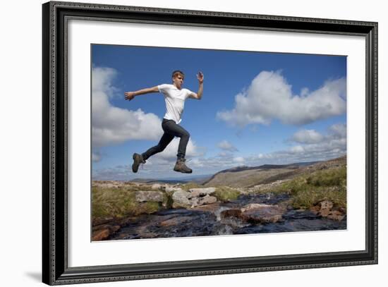 Boy (Aged 17) Jumping across Upland Stream-Mark Hamblin-Framed Photographic Print