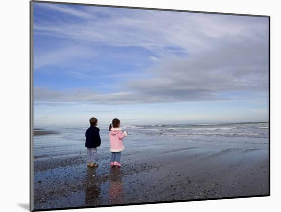 Boy Aged Four and Girl Aged Three on a Black Volcanic Sand Beach in Manawatu, New Zealand-Don Smith-Mounted Photographic Print
