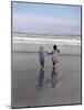 Boy and Girl on at Edge of Ocean Running and Holding Hands.-Nora Hernandez-Mounted Giclee Print