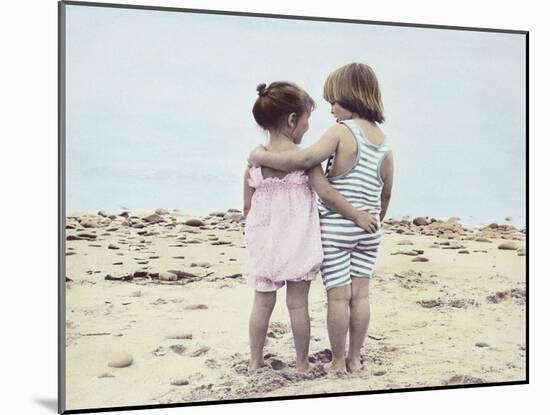 Boy and Girl with their Arms around Each Other on the Beach-Nora Hernandez-Mounted Giclee Print