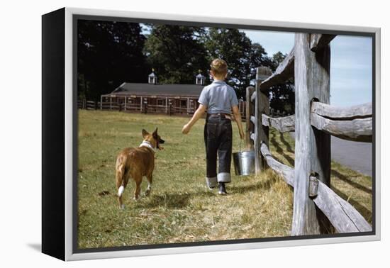 Boy and His Dog Walking Along a Fence-William P. Gottlieb-Framed Premier Image Canvas